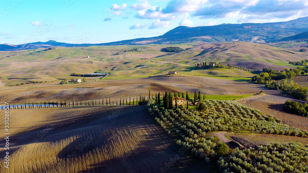 Drone flying over a magnificent authentic Italian villa  and green meadows. Aerial view Tuscany, Italy