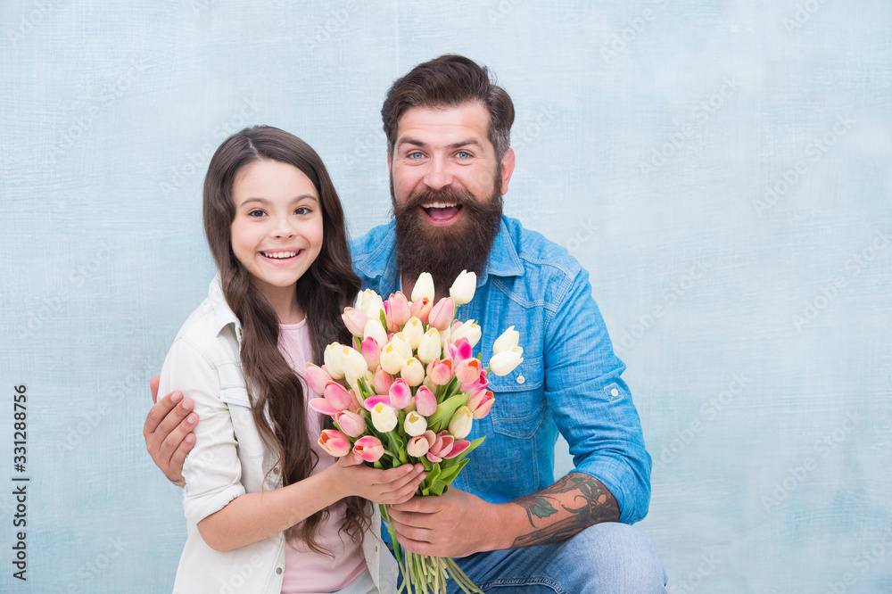 These flowers are for you. Father and daughter with happy faces hug. spring holiday time. tulip flowers for her. fresh womens day present. fathers day. ready for mothers day. congratulate with flower These flowers are for you. Father and daughter with happy faces hug. spring holiday time. tulip flowers for her. fresh womens day present. fathers day. ready for mothers day. congratulate with flower