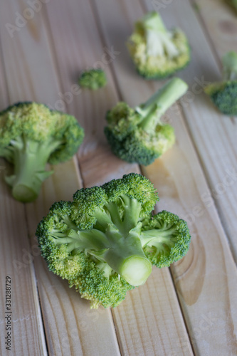 green healthy broccoli on light wood