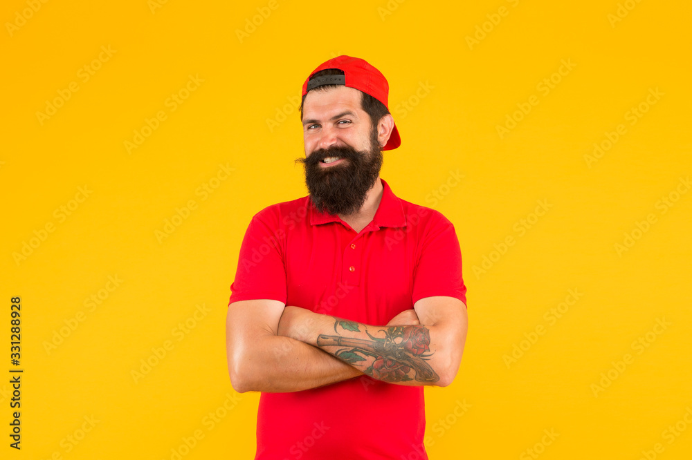 Confident and stylish. Happy hipster yellow background. Bearded man in trendy hipster style. Hipster lifestyle. Cool hipster with beard wear baseball cap. Fashion and style. Barbershop. Beard barber Confident and stylish. Happy hipster yellow background. Bearded man in trendy hipster style. Hipster lifestyle. Cool hipster with beard wear baseball cap. Fashion and style. Barbershop. Beard barber
