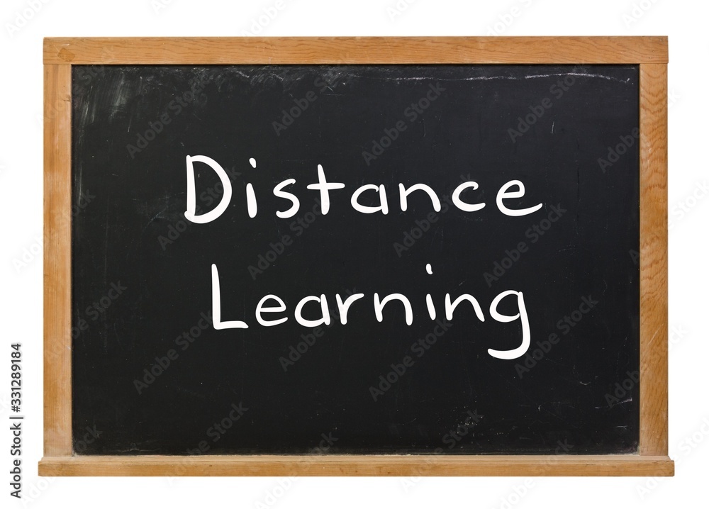 Distance learning written in white chalk on a black chalkboard isolated on white Distance learning written in white chalk on a black chalkboard isolated on white