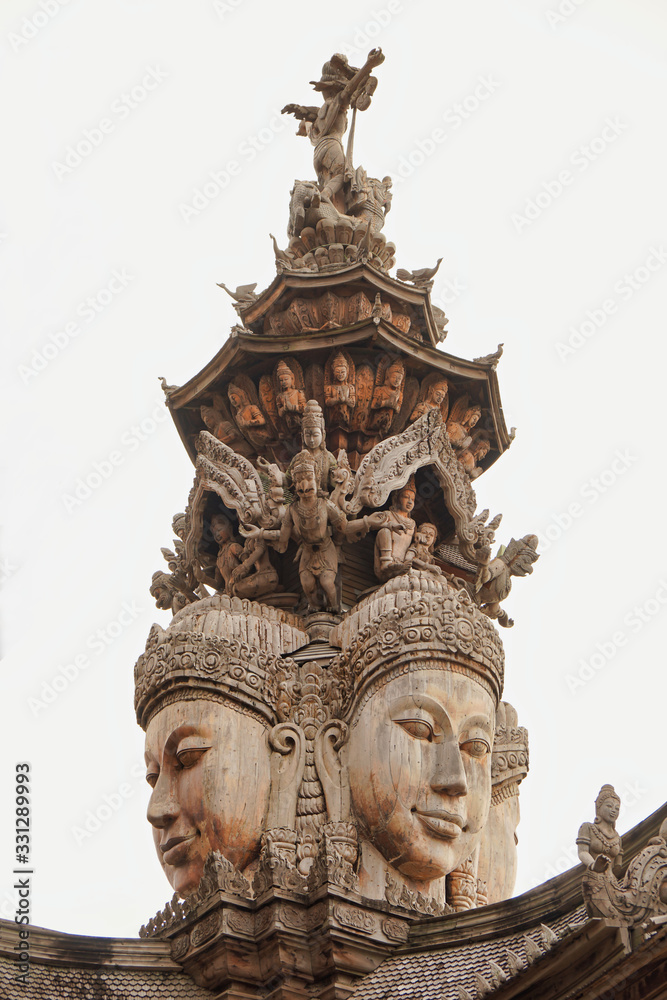 The top of the wooden castle is designed as a picture of an ancient face in Thailand and isolate background.