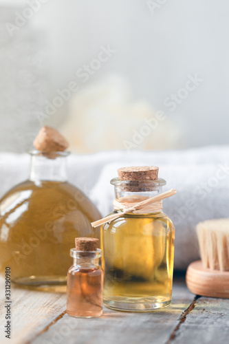 Concept of using natural oil in cosmetology. Moisturizing skin care. Gentle body treatment. Atmosphere of harmony, relax, spa, aromatherapy. Copy space for text, wooden background