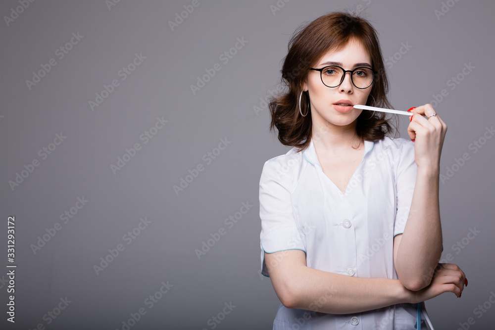 Portrait of an attractive Hispanic physician who holds a spatula to examine a sick patient Portrait of an attractive Hispanic physician who holds a spatula to examine a sick patient