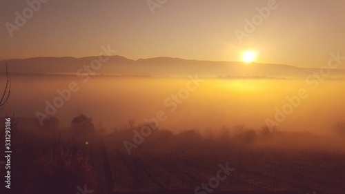 sunrise in fog mountains