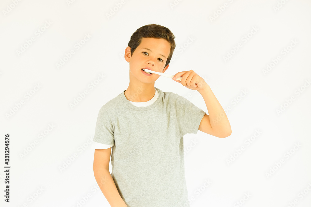 Young beautiful boy is brushing teeth Young beautiful boy is brushing teeth
