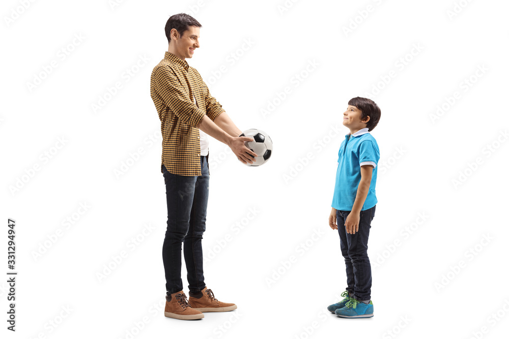 Young man giving a soccer ball to a boy Young man giving a soccer ball to a boy