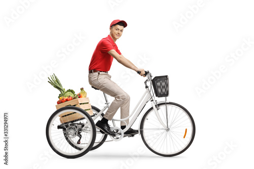 Young man delivering groceries with a tricycle