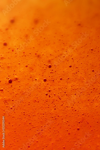 sweet orange effervescent bubble fizz. Macro close up photography. Full frame lemonade with selective focus