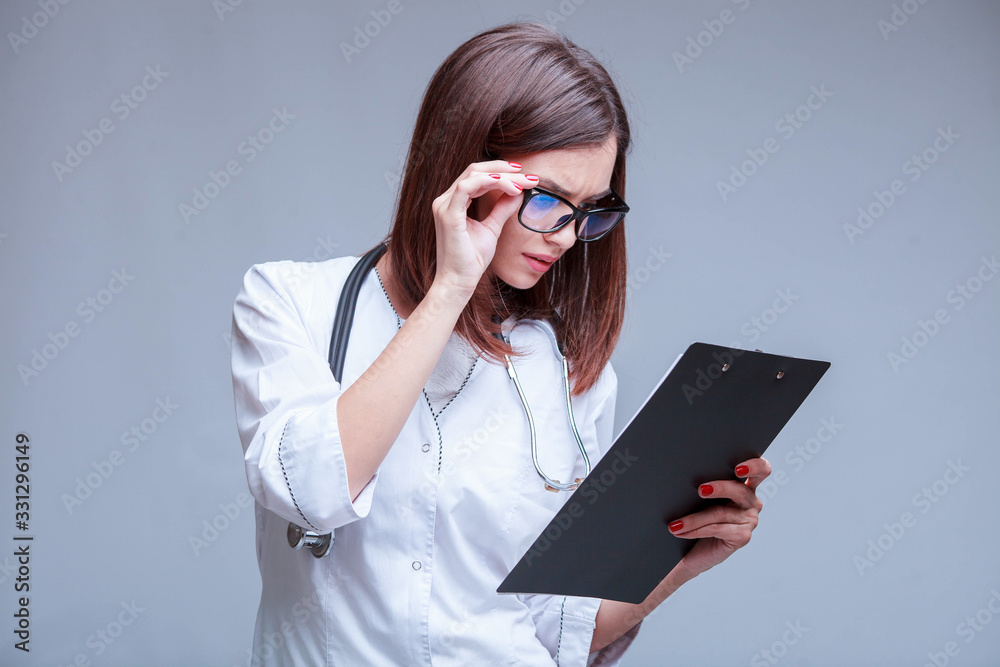 doctor wearing glasses holding medical documents about covid-19 epidemic