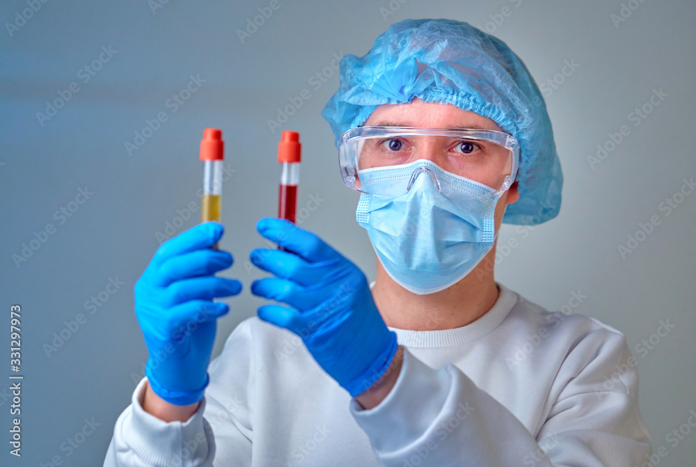 Doctor in mask holding the blood test tube, coronavirus COVID19 Doctor in mask holding the blood test tube, coronavirus COVID19