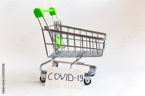 Empty shopping trolley with covid-19