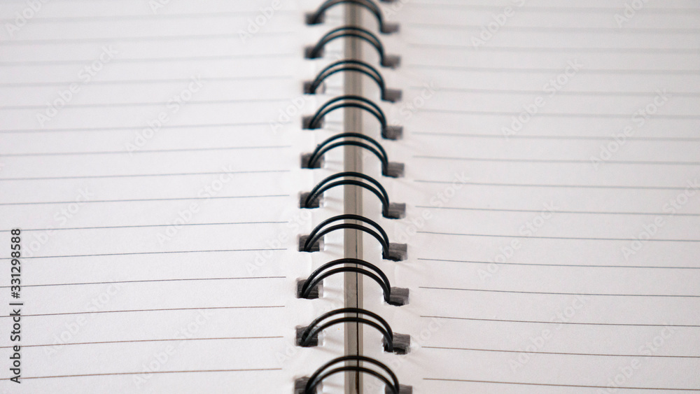 Close up top view of lines notebook or spiral notepad paper background. Memo notebook paper. Close up top view of lines notebook or spiral notepad paper background. Memo notebook paper.