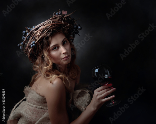  Beautiful girl in wreath with blue grapes.