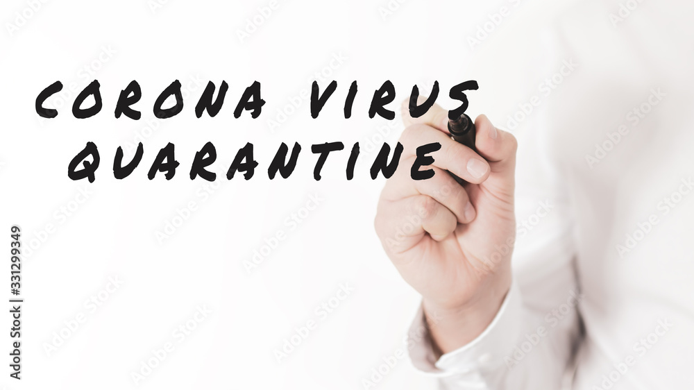 Hand of a businessman writing words Corona Virus Quarantine with black marker in a conceptual image of corona virus outbreak. Hand of a businessman writing words Corona Virus Quarantine with black marker in a conceptual image of corona virus outbreak.