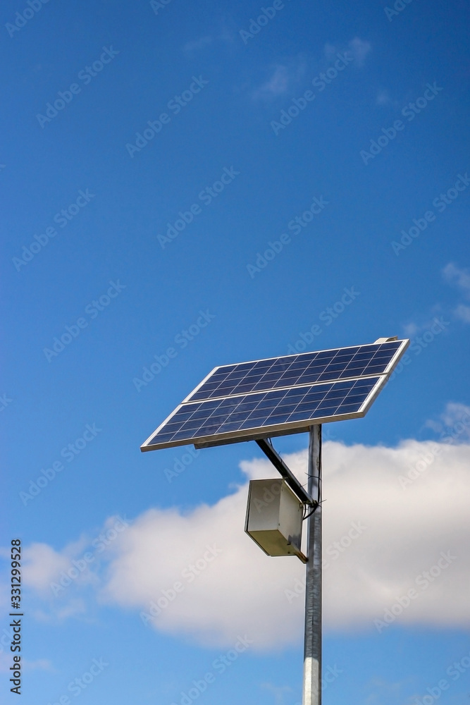 Solar panel on the post produces green, environmentally friendly sun energy