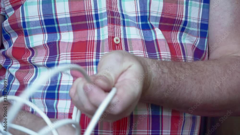 electrician at work.men's hands unravel electrical wires electrician at work.men's hands unravel electrical wires