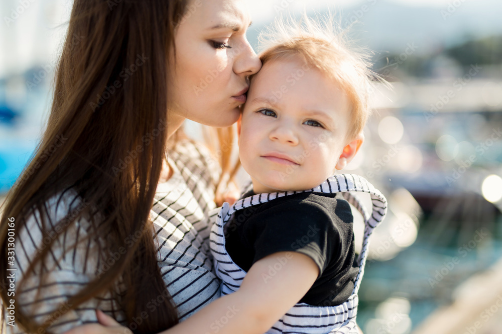 Happy mother and son on sea yacht background Happy mother and son on sea yacht background
