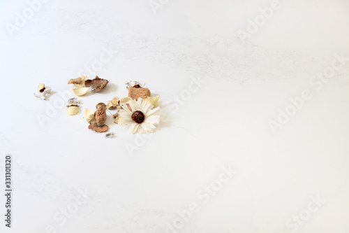Beautiful closeup of a few flowers against a white marble looking countertop made of quartz