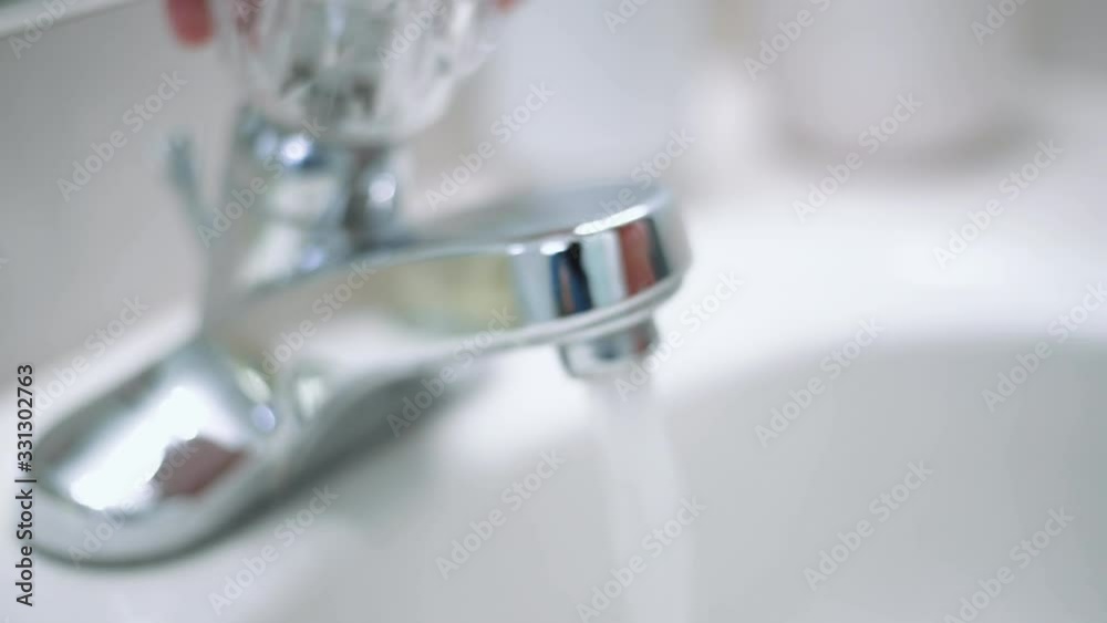 Woman getting soap from soap dispenser Woman getting soap from soap dispenser