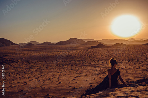 Outdoor Adventure. Sunset desert. Girl explore world. Woman exotic arabian journey. Freedom travel. Luxury holidays. Harmony concept. Copy space. Wadi Rum landscape. Jordan tourism. Sundown landscape