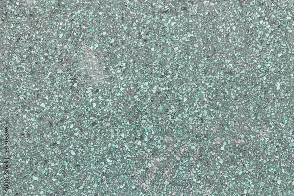 Toned photo of asphalt. Small pebbles. Green abstract background for sites and layouts.