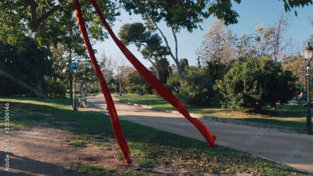 Red ribbon in the wind in Parc de la Ciutadella, Barcelona, slow motion