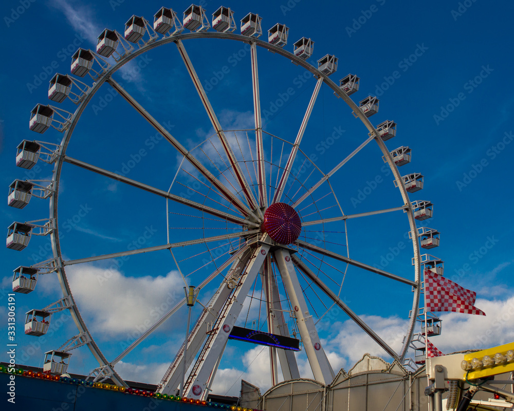 ferris wheel at traditional, historic fun fair in Bremen, Germany on a sunny day with blue sky in the background