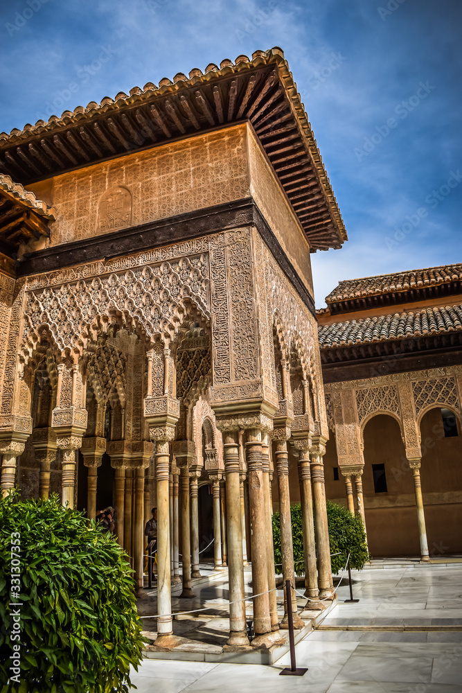 An Arabic construction in the Lion's Courtyard in La Alhambra, Granada, Spain with a blue sky