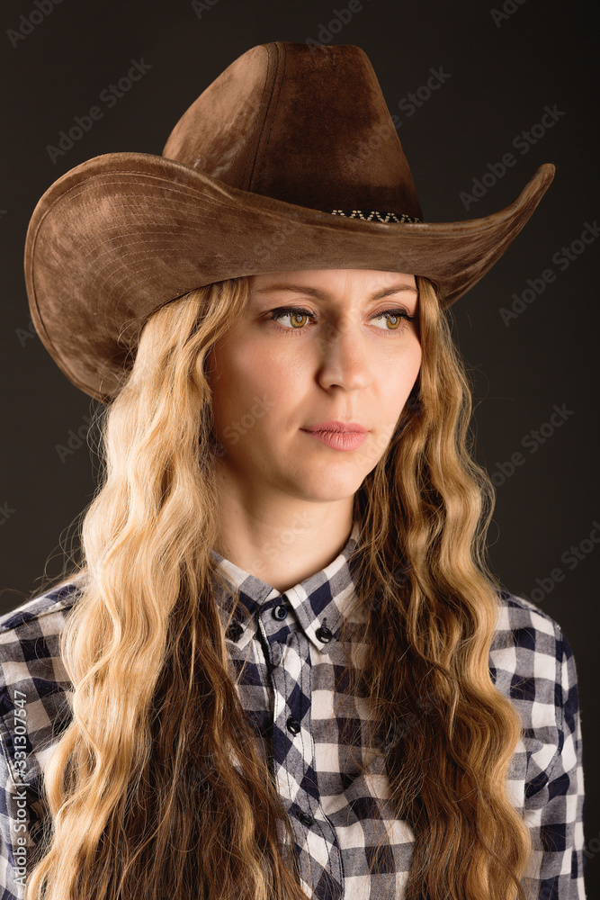 Portrait of a beautiful woman in a cowboy hat Portrait of a beautiful woman in a cowboy hat