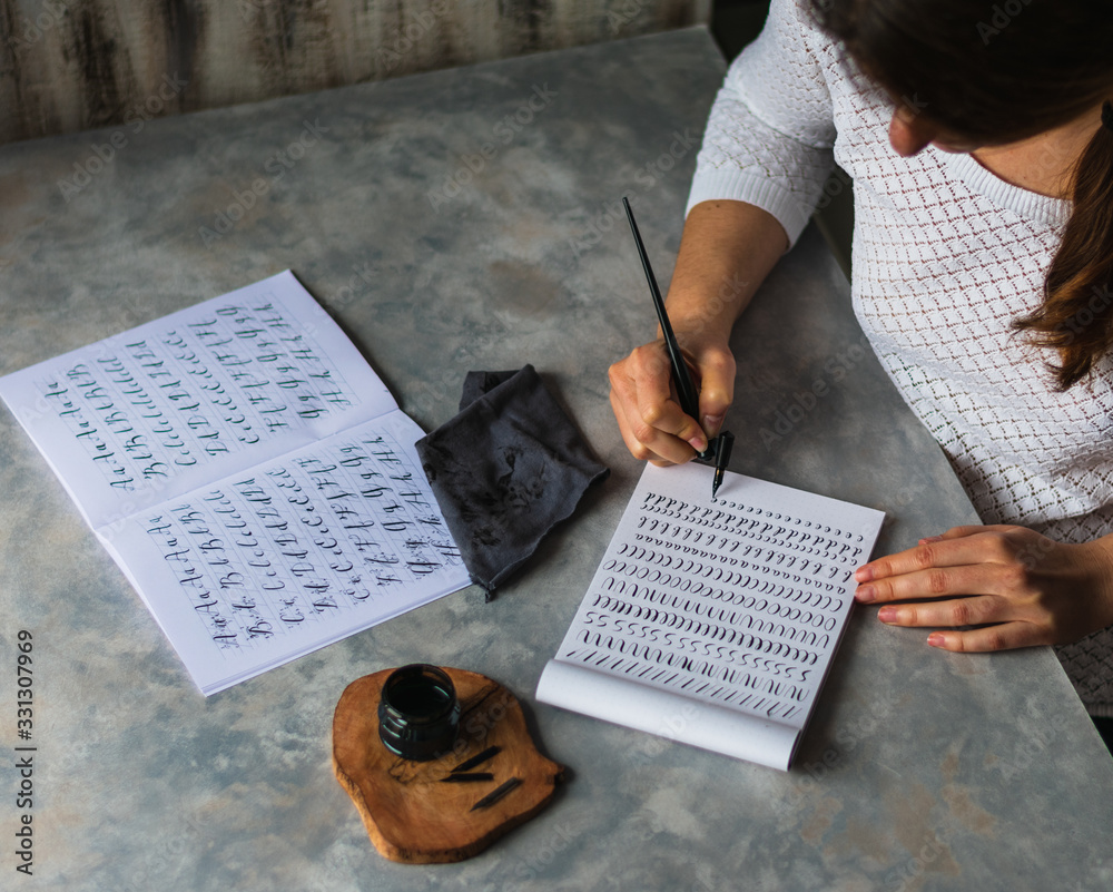 Naklejka premium White girl practicing lettering