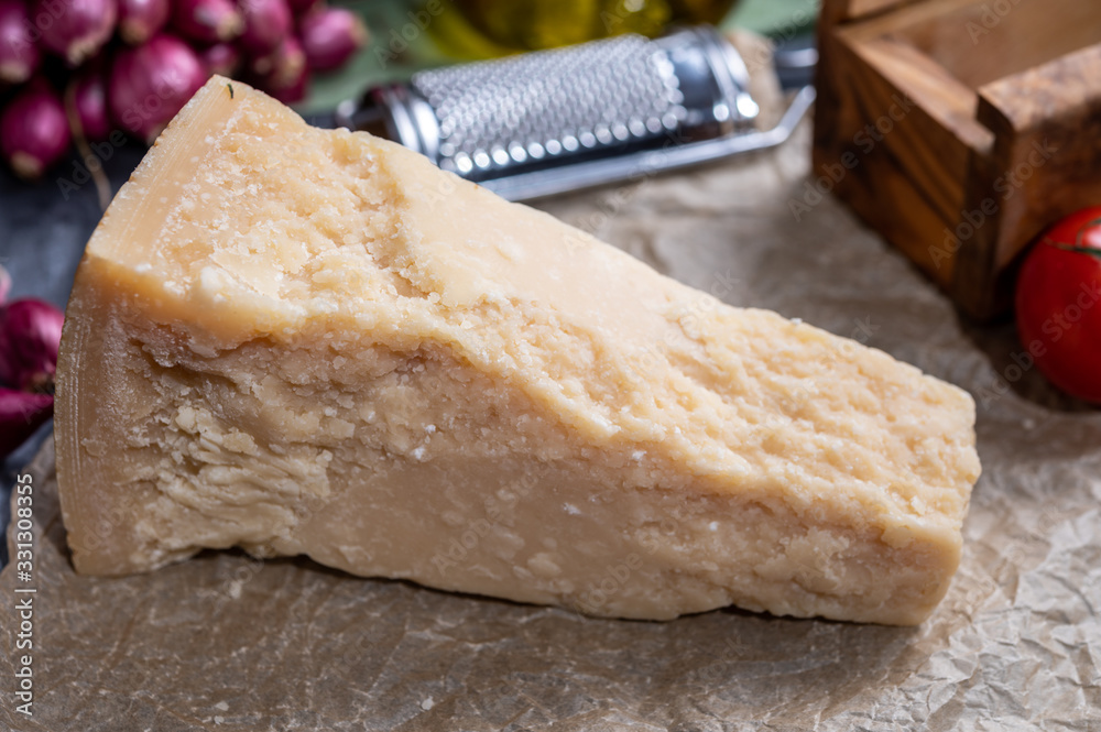 One piece of authentic Parmigiano-Reggiano or Parmesan Italian hard, granular cheese One piece of authentic Parmigiano-Reggiano or Parmesan Italian hard, granular cheese