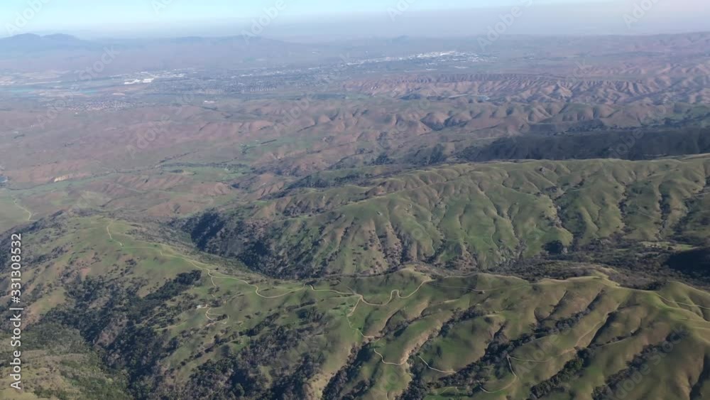 4K HD video flying over mountainous terrain in northern California. Very few clouds, hazy day. 4K HD video flying over mountainous terrain in northern California. Very few clouds, hazy day.