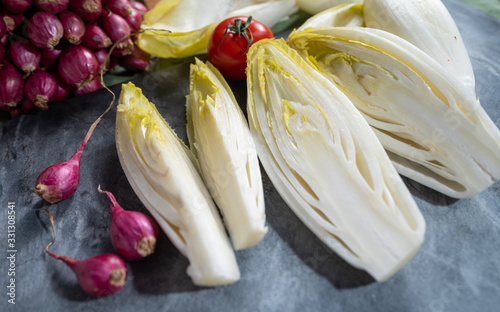 Fresh Belgian endive or chicory bitter salad ready to cook or eat