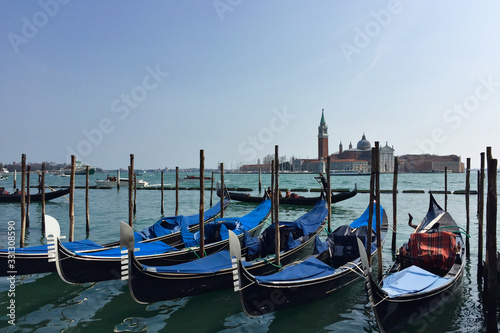 Venetian boats gondolas in harbor in Venice, Italy. © olga_demina