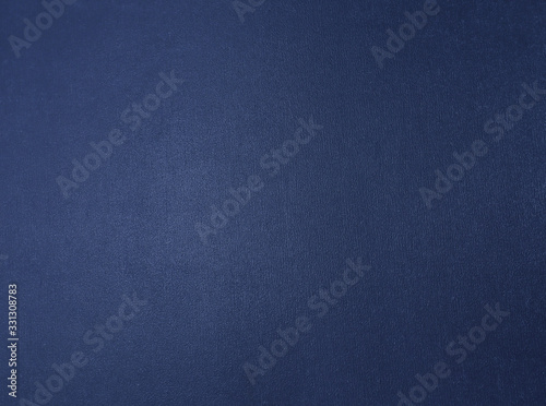 Dark blue metallic textured background with a gradient.