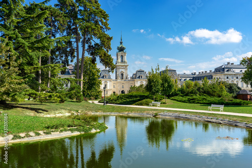 green park with a view of the Beautiful baroque Festetics Castle in Keszthely Hungary reflection in the lake pond