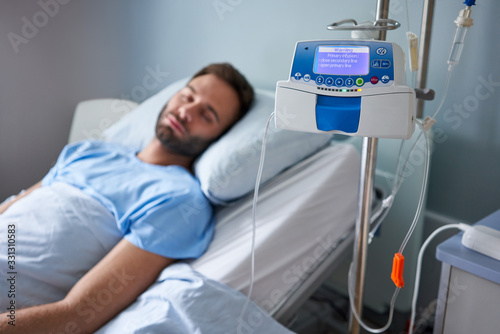 Man being treated with an infusion pump in a hospital photo