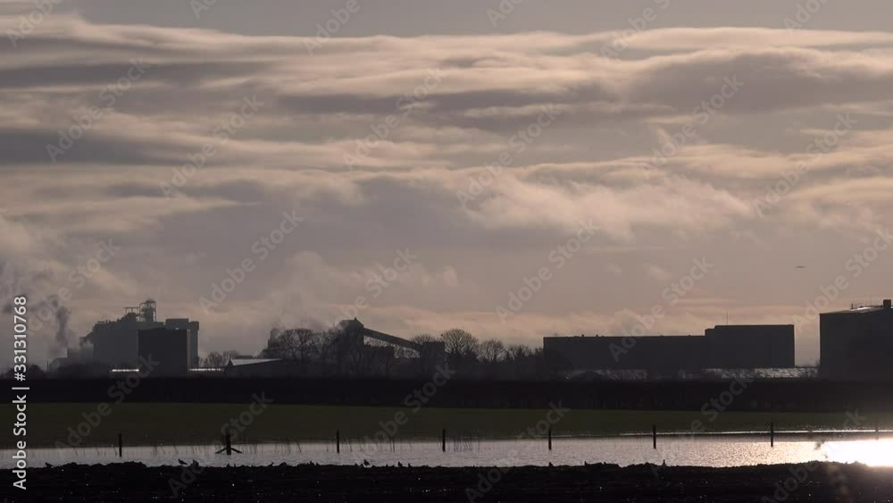 Morning light with industry and golden sky UK 4K