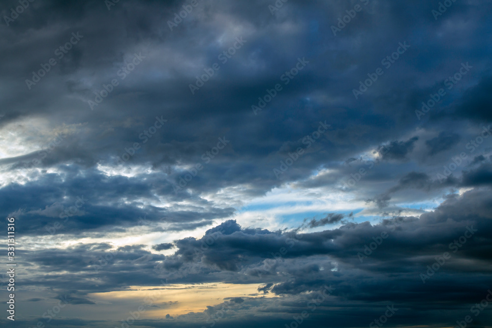 Background of dramatic sky with dark clouds. Sky before a thunder-storm. Abstract natural sky background.