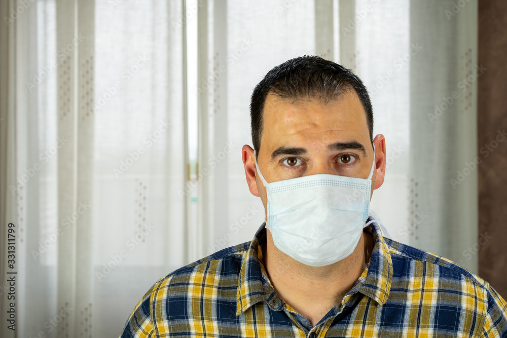 Man in checkered shirt and face mask posing Man in checkered shirt and face mask posing