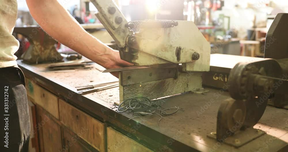 Bladesmith cutting metal with hydraulic cutter Bladesmith cutting metal with hydraulic cutter