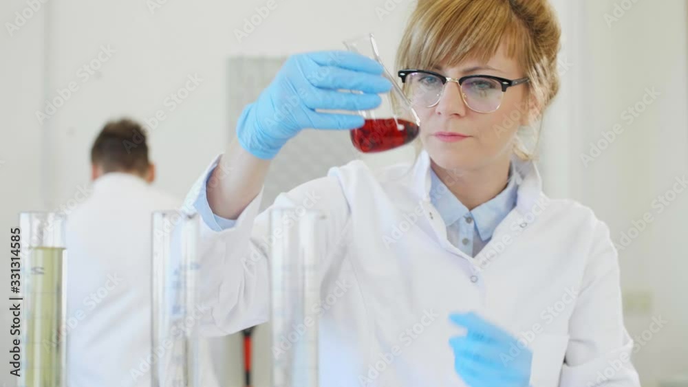 Chemist working with hemp CBD oil and tablet in laboratory Chemist working with hemp CBD oil and tablet in laboratory
