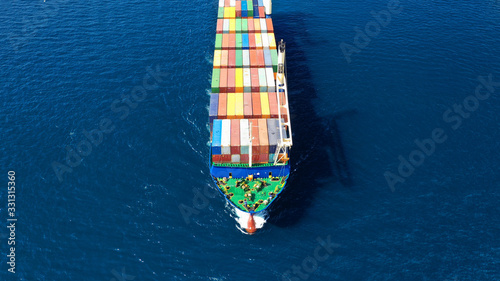 Aerial drone top down photo of fully loaded large truck size container tanker ship cruising the Mediterranean deep blue sea © aerial-drone