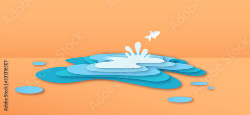 Paper cut fish jumping in water puddle concept