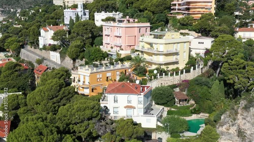 France, Cote Dazur, Beaulieu, 02 October 2019: Aerial view of French Riviera's terraces of expensive country houses and estates, palm trees, pools, stony coast, Chaise lounges photo