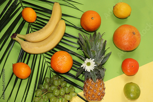 Fototapeta Naklejka Na Ścianę i Meble -  Summer banner, citrus fruits, grapefruit, orange, lemon, pineapple on a yellow background, pattern, minimal rest concept, diet, healthy food. Place for text, flat lay, food delivery.