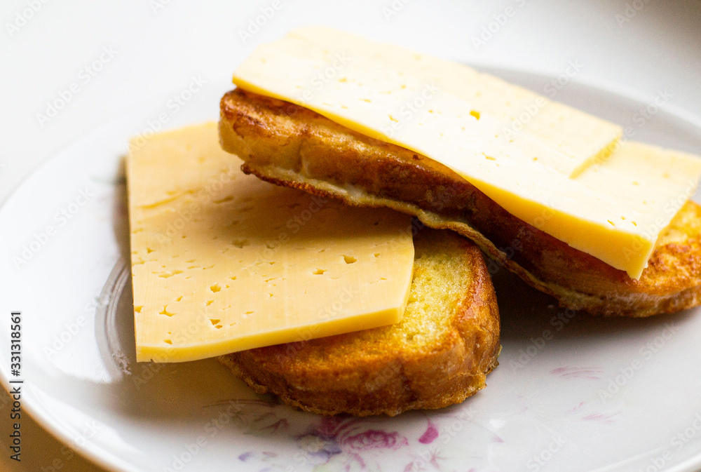 fried slices of white bread with cheese on a plate.