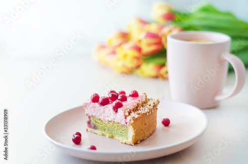 flowers tulips, cake, tea in pink mug on white background closeup. womens, mothers, Valentines Day, birthday. copy space, soft focus