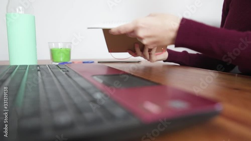girl opening notebook to take notes in front of the or